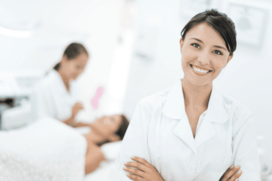 Medical professionals in white coats working in a modern clinical setting with blurred background elements.